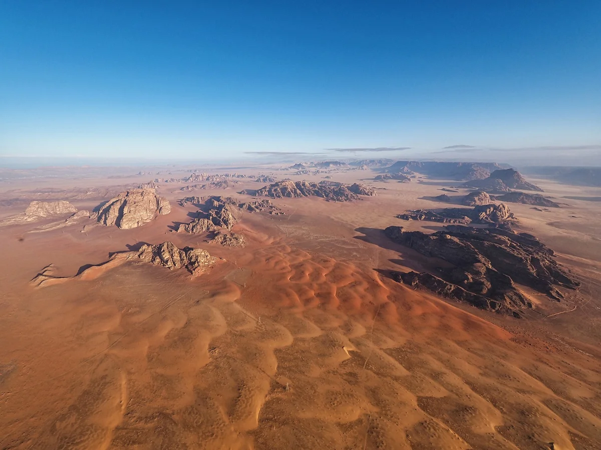 Red sand and rock seen from the basket on a Wadi Rum hot air balloon flight