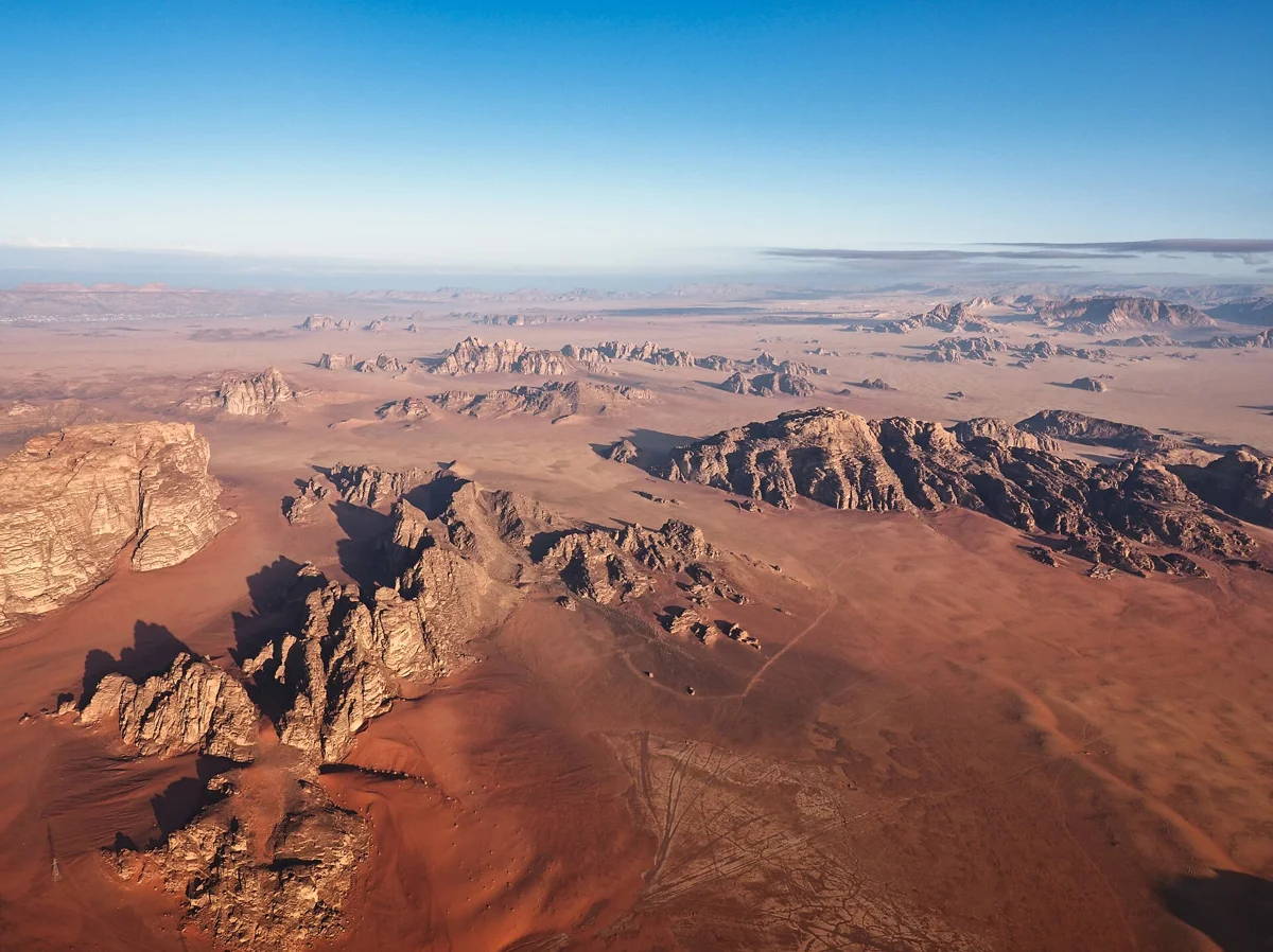Rock islands in the sand below a Wadi Rum hot air balloon